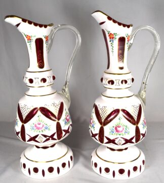 PAIR OF BOHEMIAN WHITE CUT TO CRANBERRY EWERS
