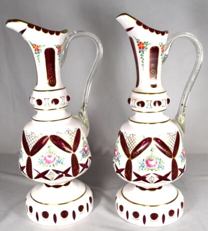 PAIR OF BOHEMIAN WHITE CUT TO CRANBERRY EWERS